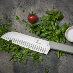 Swiss Modern Colors 7.5" Granton Edge Santoku Knife In Olive Green By Victorinox 14 Swiss Modern Colors 7.5" Granton Edge Santoku Knife In Olive Green By Victorinox -Chefs Knives Store VF6905617K6 Swiss Modern Santoku Close up